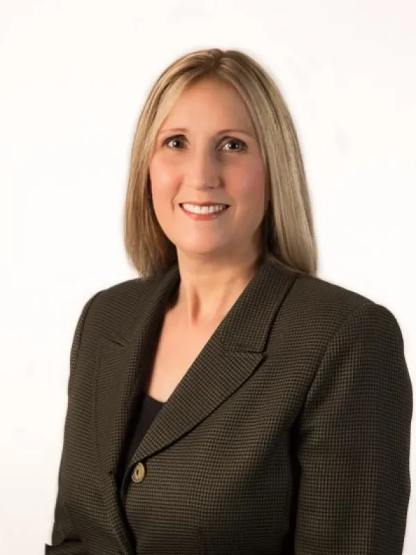Smiling woman with blonde hair in business professional attire